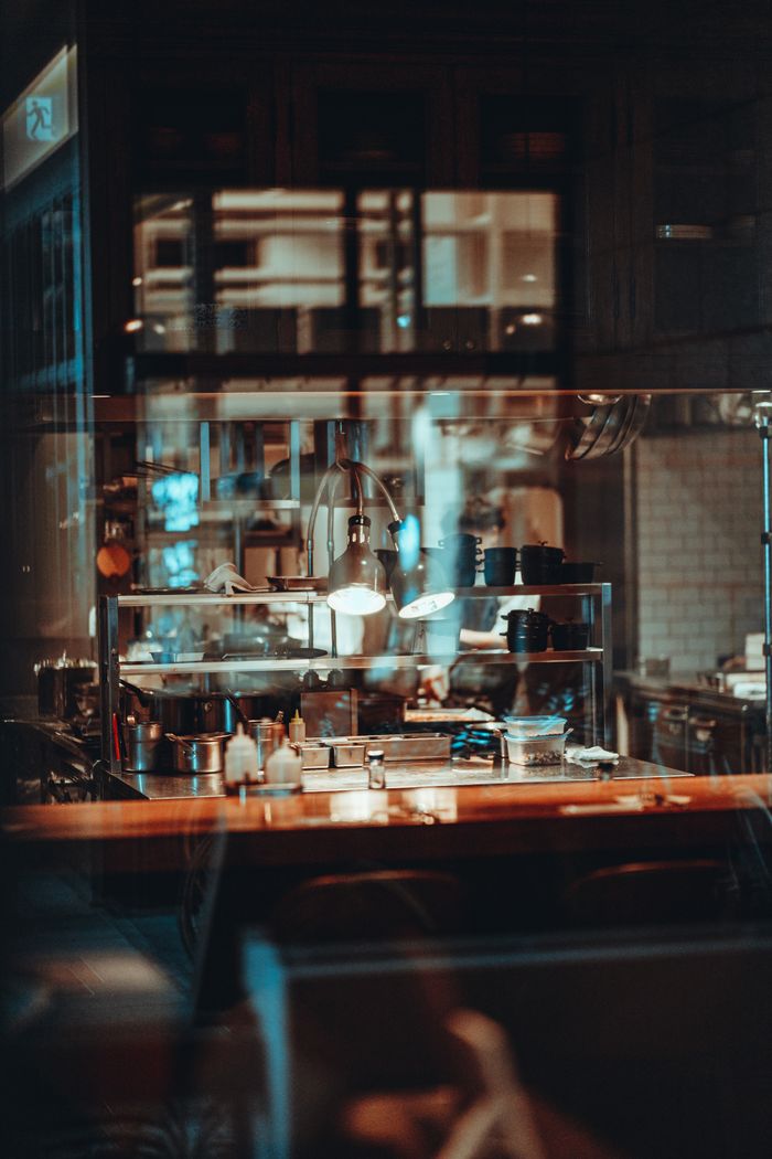 Services Warm café interior in Tokyo with wooden counter and ambient lighting, creating a cozy urban atmosphere.