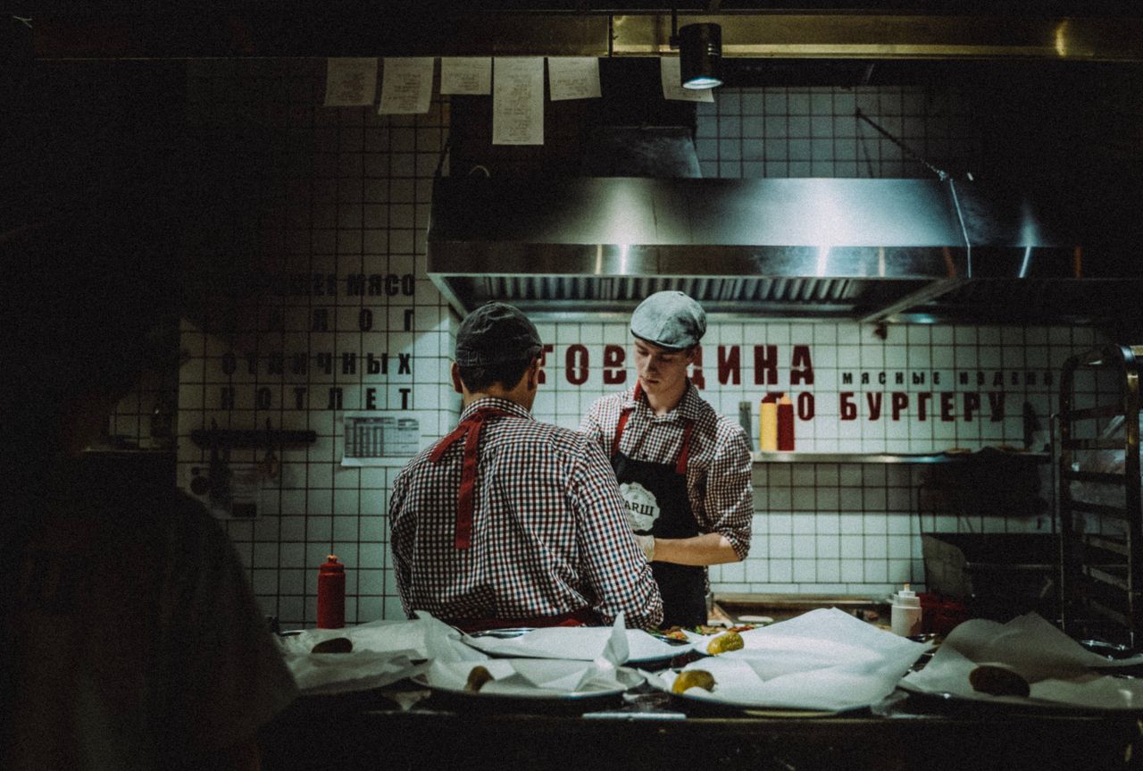 Crafting Captivating Headlines: Your awesome post title goes here Chefs working in dimly lit kitchen, preparing food. Atmosphere is rustic and industrial.